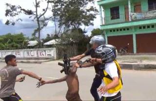 Indonesian police and plain clothes agents beat an unarmed Papuan