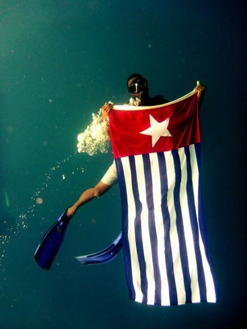 The Morning Star flag proudly held under the seas of Vanuatu.