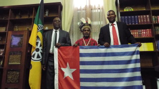 Benny Wenda raising the West Papuan flag with Mr PS Sizani MP, the Chief Whip of the African National Congress (ANC) and Mr Nkosi Mandla Mandela MP, the grandson of Nelson Mandela.